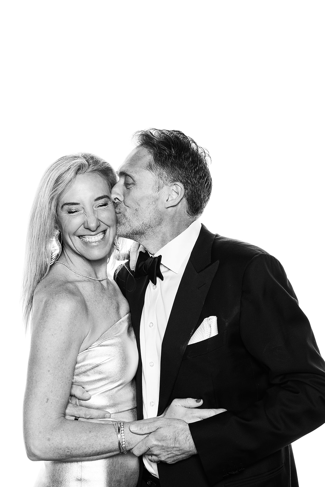 Couple with man kissing him wife on the temple