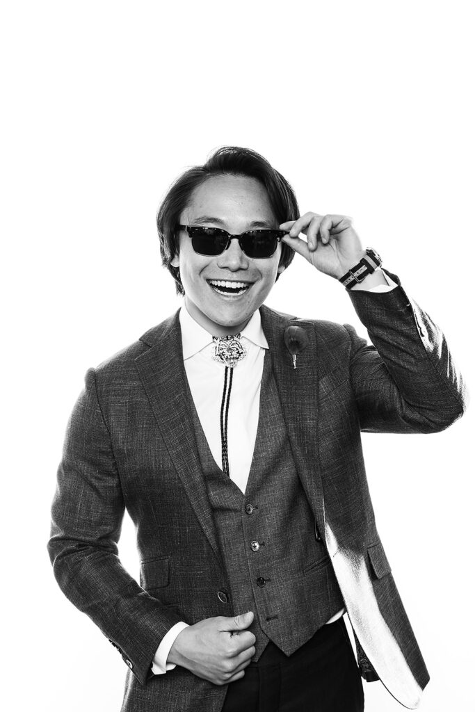 man in suit with bolo tie and sunglasses in glam booth 