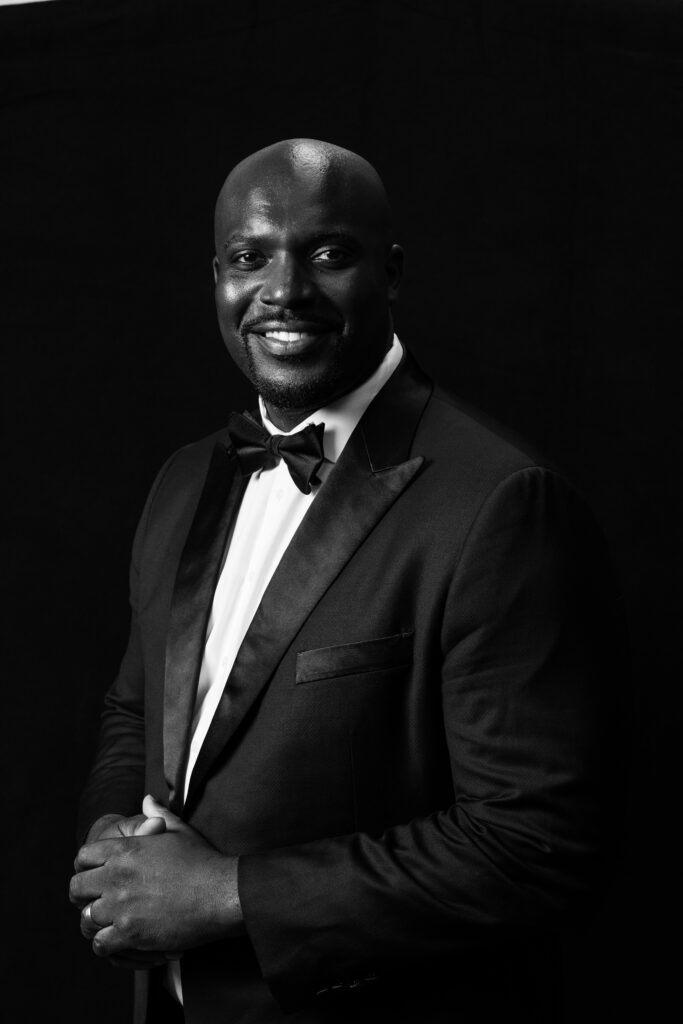 Black and white headshot of a man in a suit