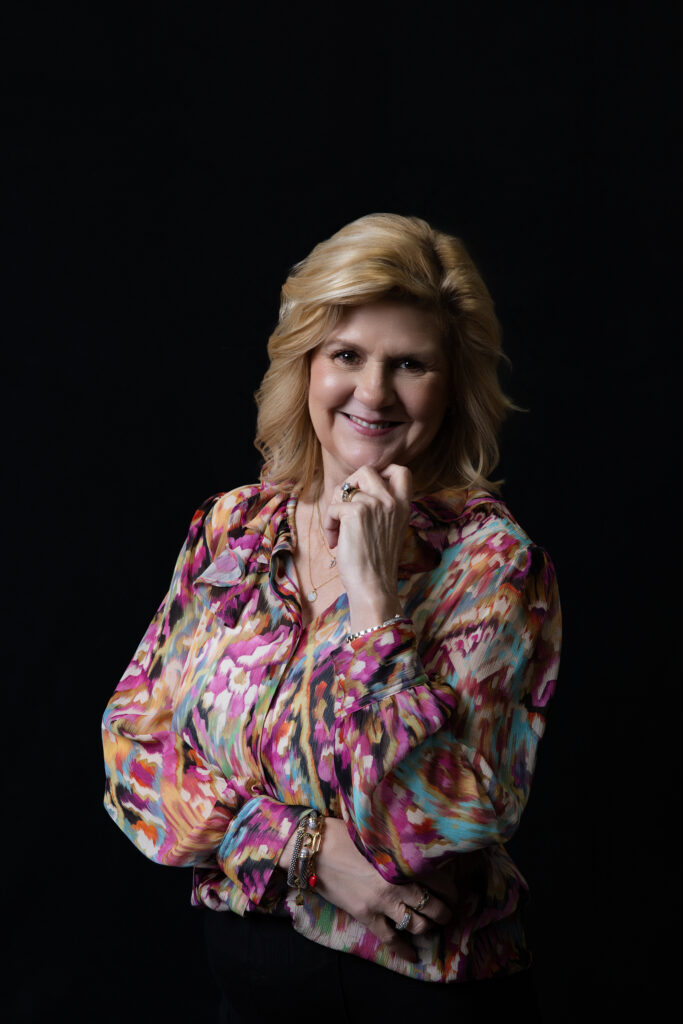 headshot of a women on a black backdrop