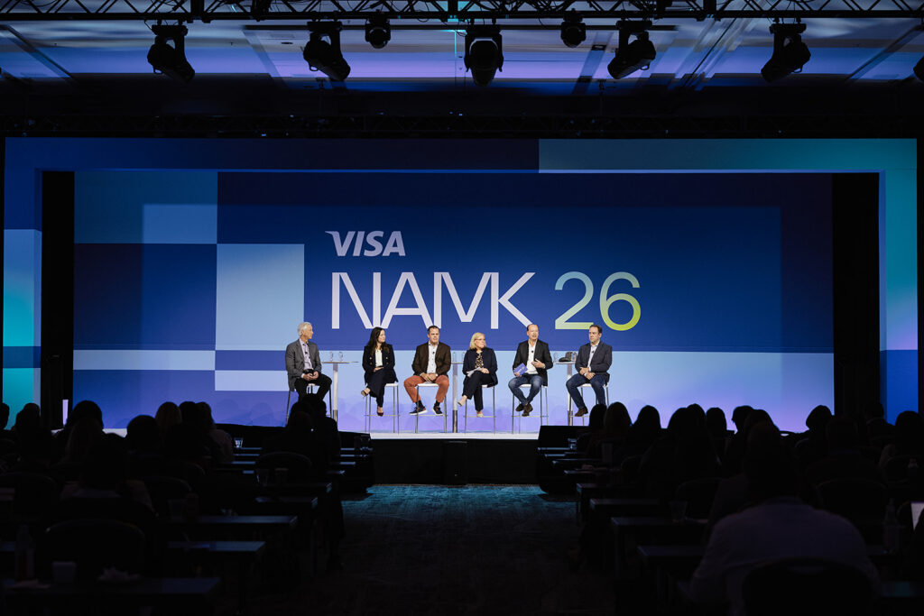 6 people on stage having a fire side chat 