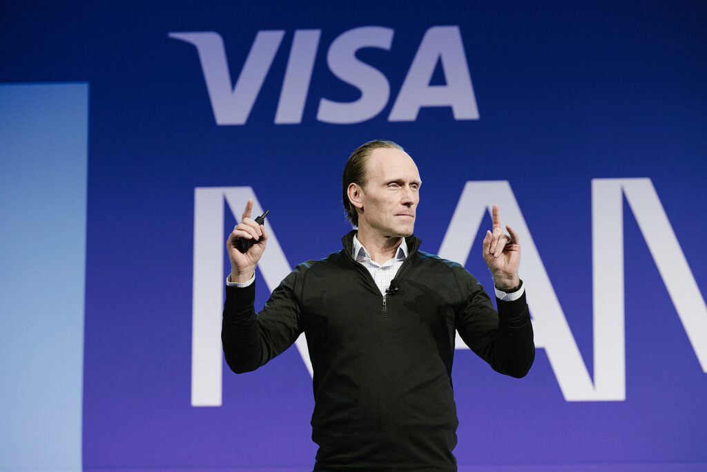 Man speaking on a stage at visa NAMK26