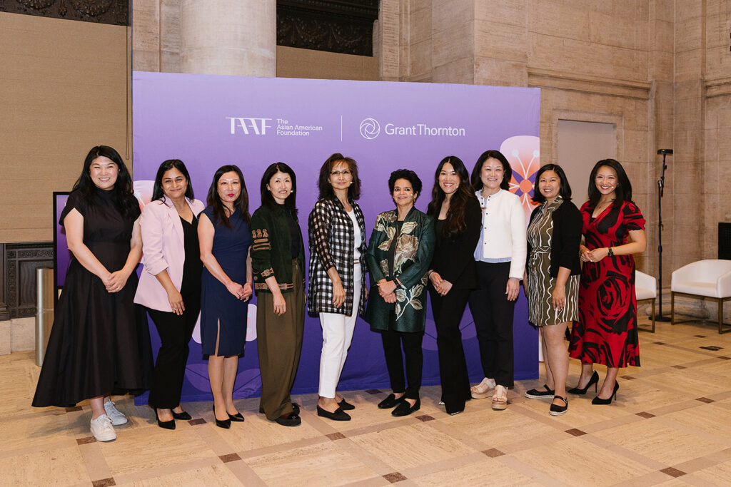 Group photo of 10 women in front of a backdrop