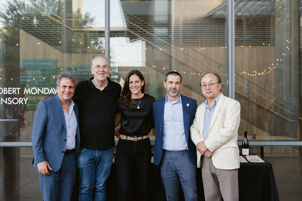 Group photo in front of the Robert Mondavi Institute for Wine and Food Science signage.